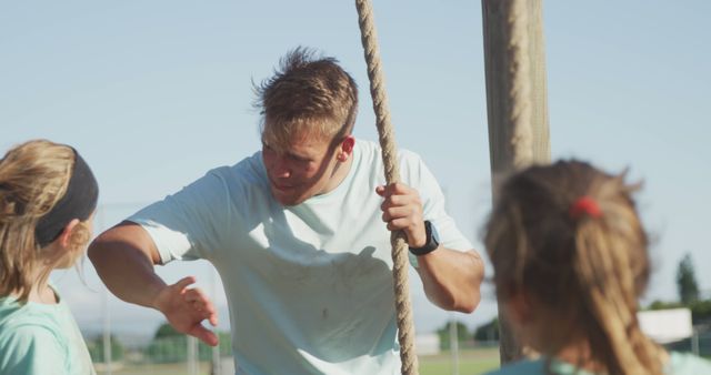 Fitness Coach Encouraging Young Girls During Rope Climbing Training - Download Free Stock Images Pikwizard.com