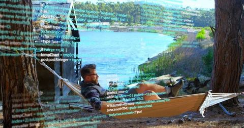 Coder in hammock beside lakeside cabin for creative programming concept