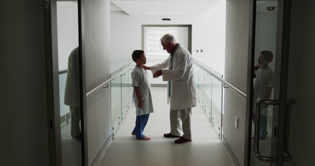 Doctor Consulting with Child Patient in Hospital Hallway - Download Free Stock Images Pikwizard.com