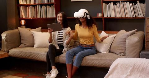 Diverse Friends Enjoying Virtual Reality Experience in Cozy Home Setting