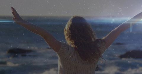 Woman Stretching on Beach at Sunset