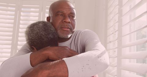 Senior African American Couple Embracing in Warm Sunlight