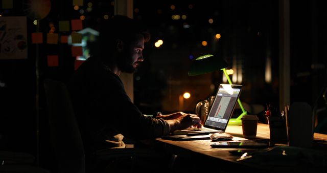 Focused Man Working Late Night on Laptop in Office - Download Free Stock Images Pikwizard.com