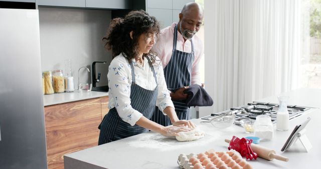 Couple Baking in Modern Kitchen, Woman Kneading Dough While Man Assists - Download Free Stock Images Pikwizard.com