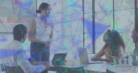 Woman leading team presenting strategy in bright office, collaboration and digital network