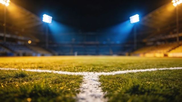 Night soccer pitch corner close-up with white line, lush grass, dramatic floodlight glow