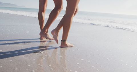 Couple Strolling on Sunny Beach - Download Free Stock Images Pikwizard.com