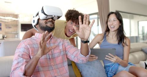Diverse Friends Enjoying Virtual Reality Experience at Home