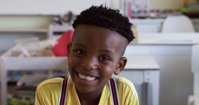 Smiling Child in Classroom with Bright Yellow Shirt - Download Free Stock Images Pikwizard.com