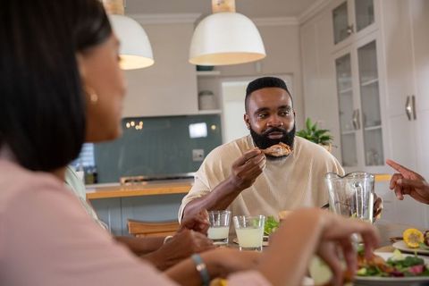 Diverse Friends Enjoying Meal in Modern Kitchen