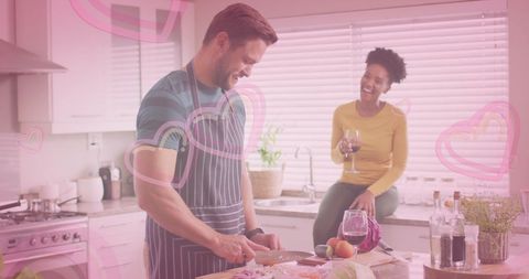 Happy Couple Cooking and Enjoying Wine in Modern Kitchen
