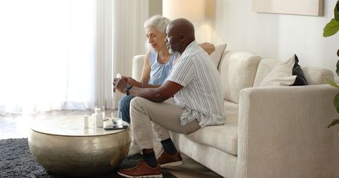Senior Couple Discussing Medication in Cozy Living Room