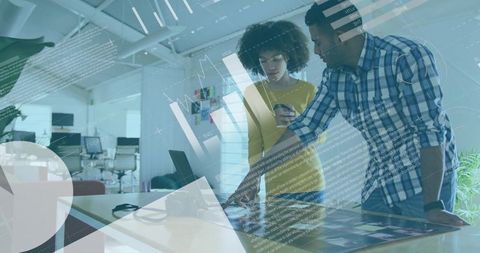 Team collaborating on interactive touchscreen display in modern open-plan office