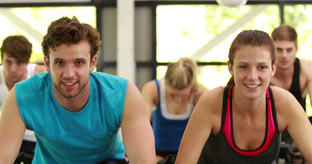 Group of Young Adults Exercising at Indoor Cycling Class - Download Free Stock Images Pikwizard.com