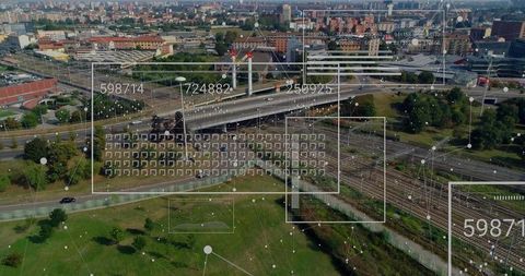 Aerial city overpass and railway with digital data overlays visualizing transit analytics