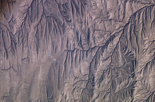Aerial view of the rugged mountain ranges in North Central China, showcasing the dramatic geological features and natural beauty of the region. Ideal for use in nature-related content, geological studies, environmental awareness campaigns, and educational materials highlighting Earth's natural landscapes.