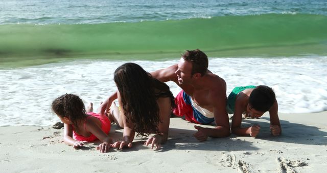 Family Having Fun Together Lying On Beach Near Waves - Download Free Stock Images Pikwizard.com