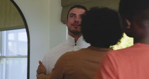 Groom preparing with caring friends for wedding day