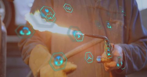 Technician Using Torch with Augmented Reality Icons in Industrial Workshop