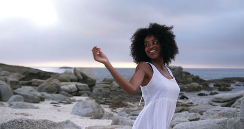 Joyful Young African American Woman Dancing on a Beach