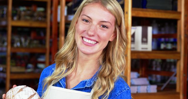 Smiling Female Baker Holding Freshly Baked Bread in Bakery - Download Free Stock Images Pikwizard.com