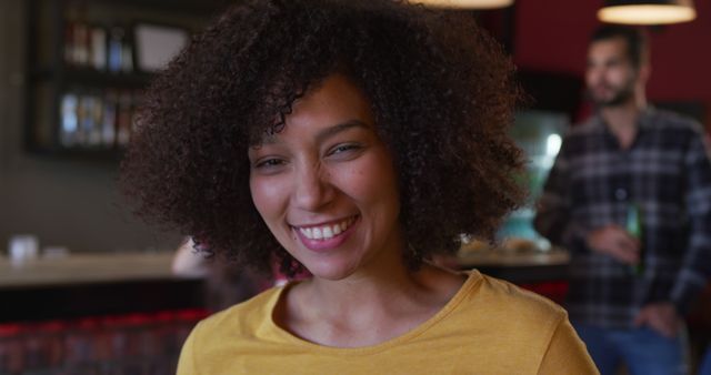 Smiling Woman with Curly Hair in Casual Setting - Download Free Stock Images Pikwizard.com