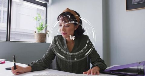 Woman at Desk with Shopping Cart Overlay Concept