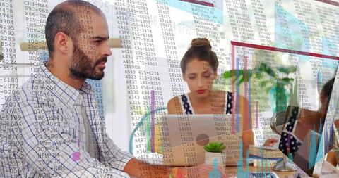 Data-driven team collaborating at shared desk with digital charts and analytics overlays
