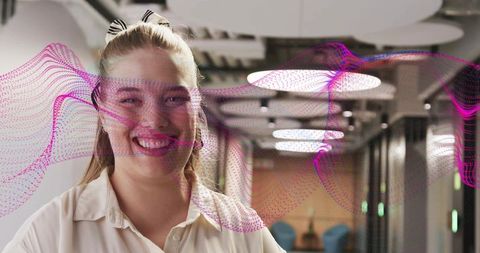 Smiling professional in modern office with digital overlay