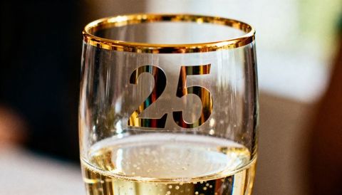 Celebrating 25th anniversary with gold-rim champagne flute