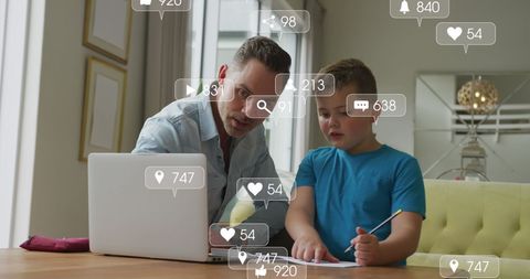 Father and Son Using Laptop with Social Media Interface