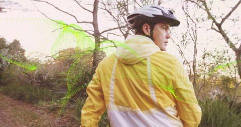 Cyclist with technology overlay on wooded trail