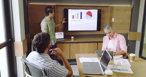 Coworkers collaborating during business presentation in modern conference room