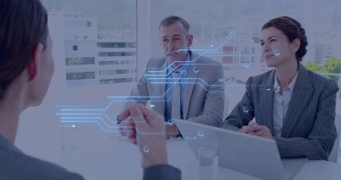 Business Leaders Analyzing Holographic Interface in Meeting