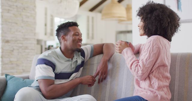 Happy african american couple talking in living room - Download Free Stock Photos Pikwizard.com