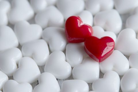 Red Hearts among White Hearts - Symbol of Love and Uniqueness