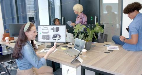 Collaborating design team developing vr headset concepts in modern coworkorking office