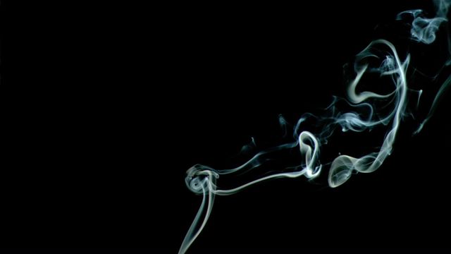 White smoke gently twisting and curling on a black background offers a visually striking composition. Perfect for designs emphasizing air movement, mystery, and elegance. Suitable for use in projects related to air purification, burning incense, metaphor for mystique, or artistic settings. Highlights the fluidity and grace of smoke in a dramatic, minimalistic style.