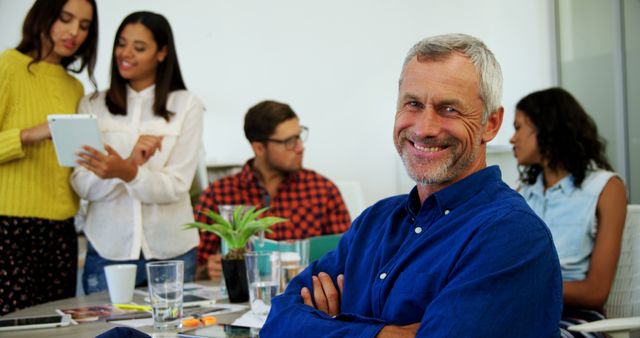 Confident Businessman Enjoying Team Meeting in Modern Office - Download Free Stock Images Pikwizard.com