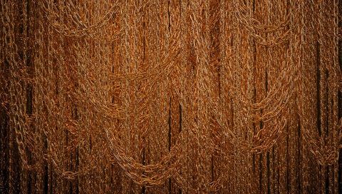 Golden chain curtain draping reflective copper loops metallic texture backdrop