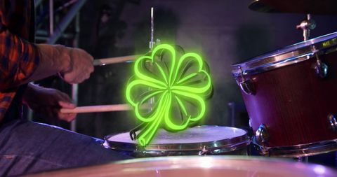 St. Patrick’s Day Neon Shamrock Over Drummer on Stage