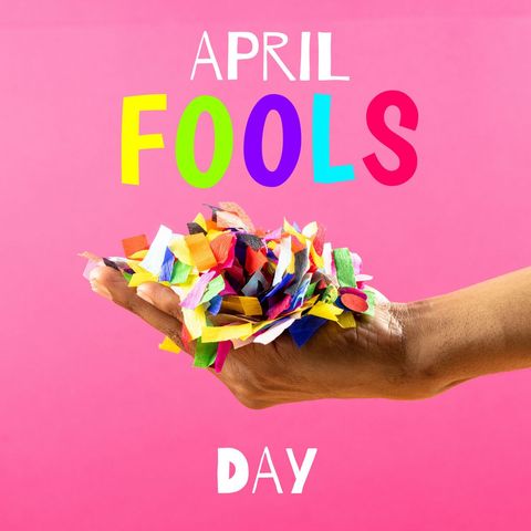Vibrant confetti in a hand represents playful celebration for April Fool's Day on a bright pink background. Perfect for advertising humor-oriented products, promoting party supplies, or illustrating festive and playful themes during this special day.