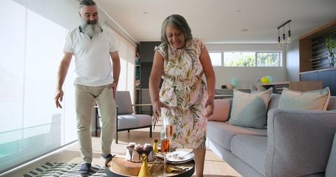 Senior Couple Dancing Joyfully in Modern Living Room