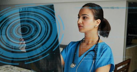 Female doctor examining transparent digital panel with futuristic hud for diagnostics