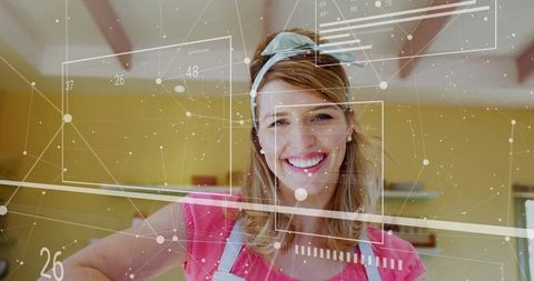 Cheerful Woman Embracing Technology in Modern Kitchen