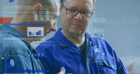 Technician collaborating and reviewing digital diagnostics charts in industrial workshop