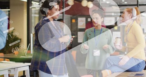 Multiracial female colleagues discuss business at work