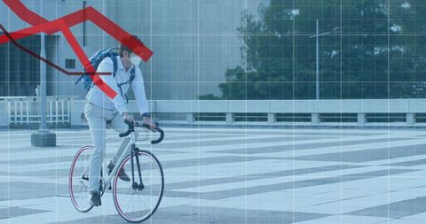 Urban asian cyclist riding road bike through plaza with data grid and falling arrow
