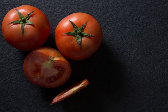 Fresh Tomatoes on Dark Slate Background - Download Free Stock Photos Pikwizard.com