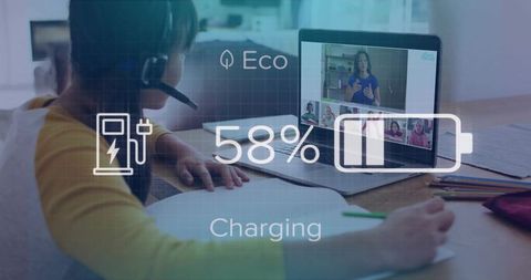 Girl studying at laptop during virtual classroom with charging battery overlay and headset